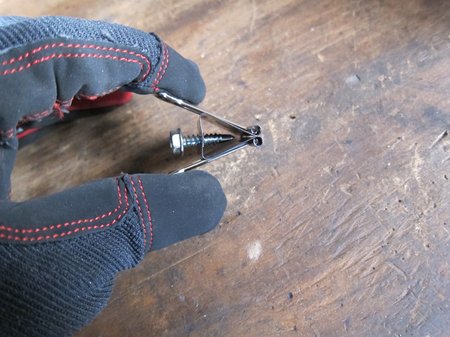 Screw installed in binder clip